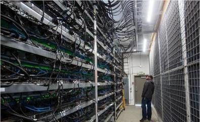 A modern mining farm with rows of mining rigs